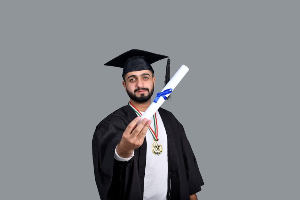 Graduate holding diploma after university admission process