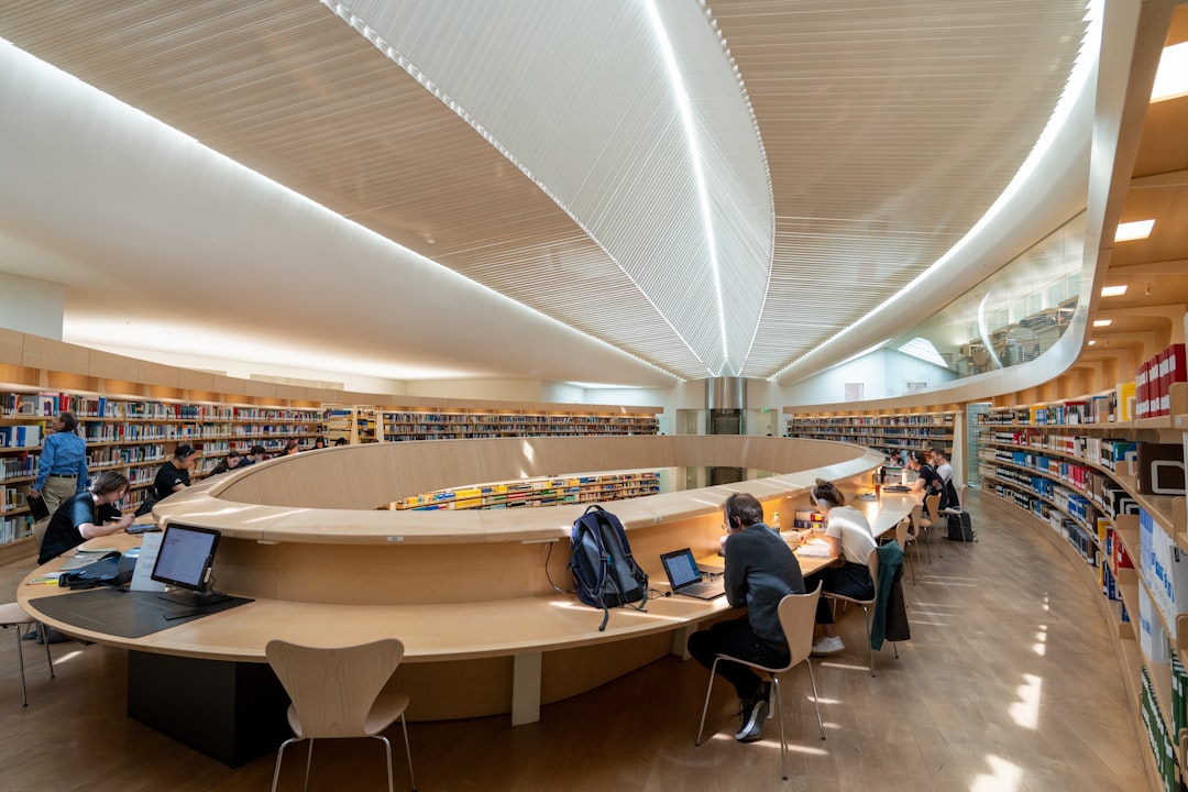 Law college library with students studying books and taking notes