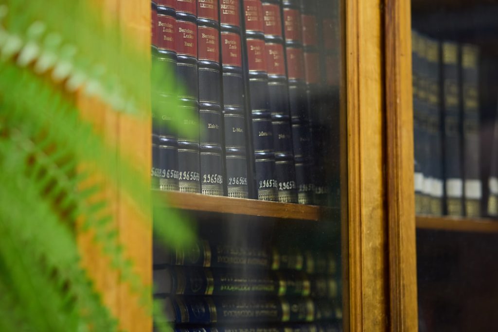 Bookshelves of old books in a library, symbolizing legal history archives
