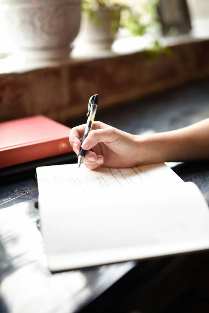 Student writing notes, representing the 3-Year LL.B. syllabus